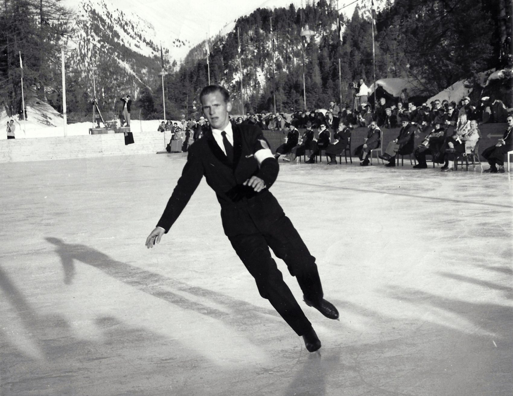 Detail of the black and white mens ice skates in action on ice