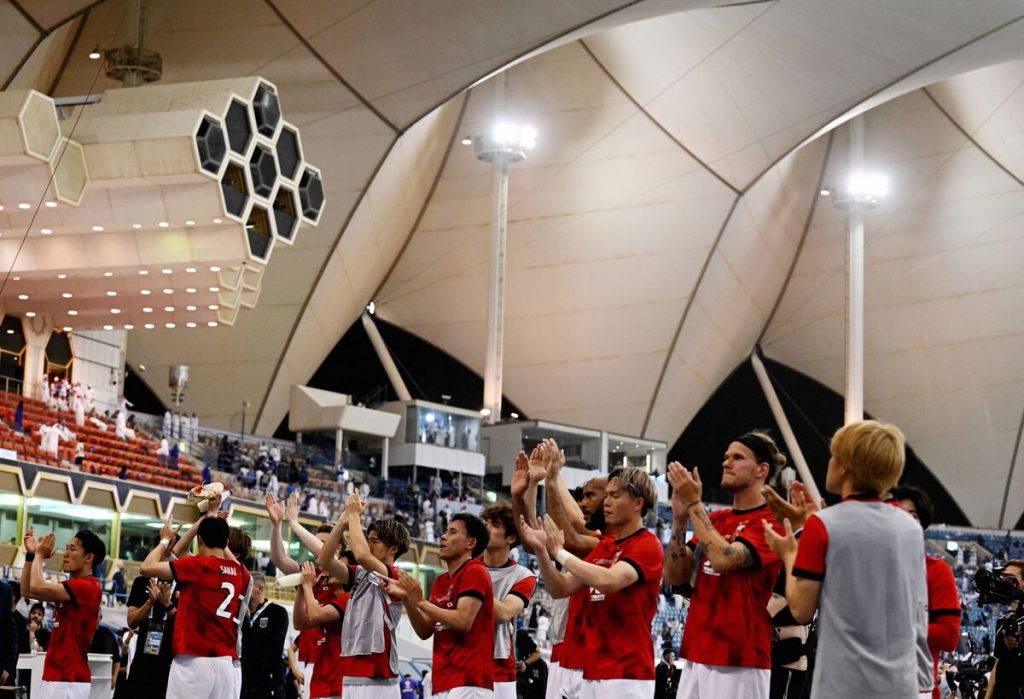 Al Hilal's Ali Al Bulayhi, right, fights for the ball with Urawa