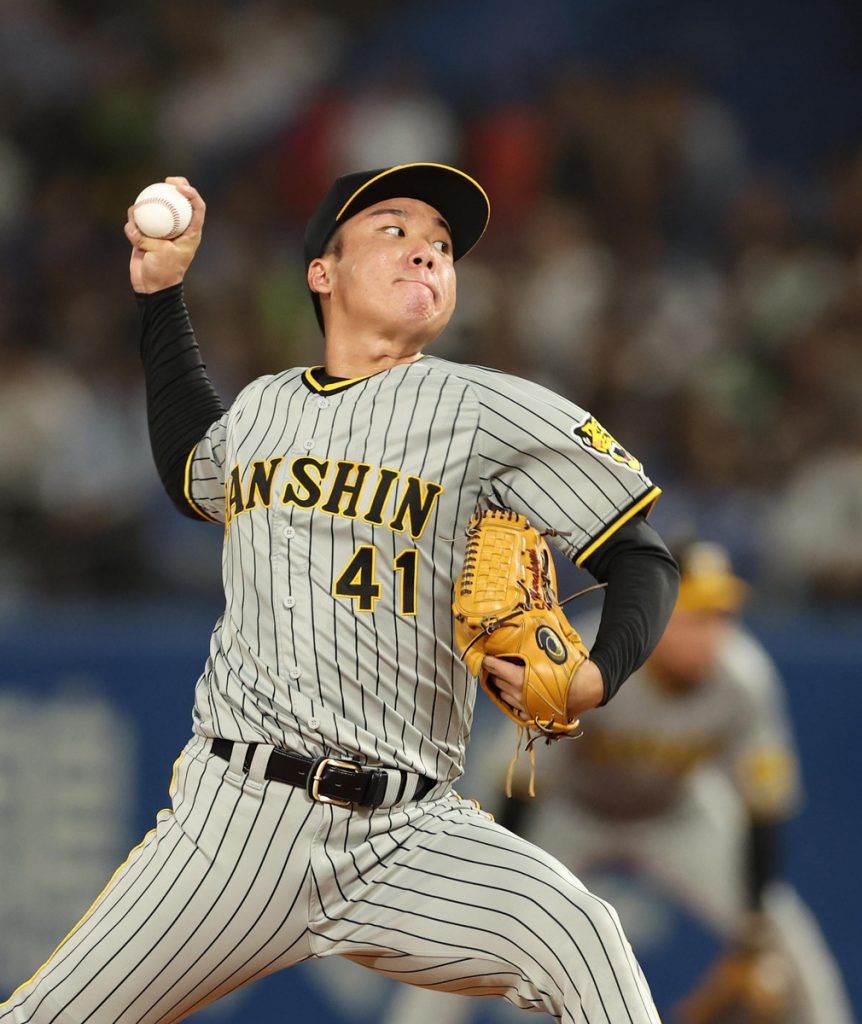 Fans of Hanshin Tigers celebrate as the team clinched their first